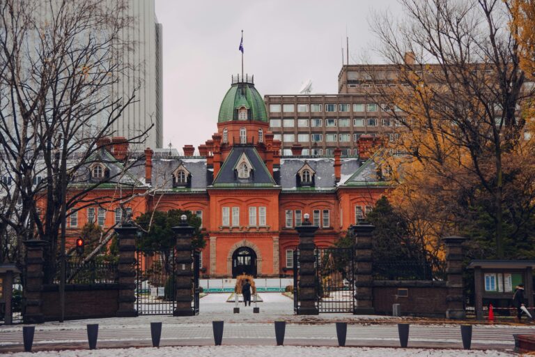 Scenic view of the old government building in Sapporo, Japan, surrounded by winter trees.