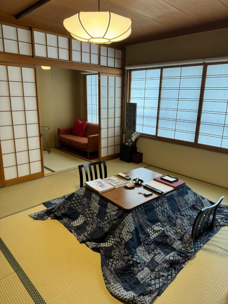 Cozy Japanese room featuring a kotatsu table and tatami mats.
