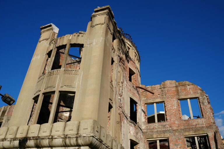 The Hiroshima Atomic Bomb Dome against a clear blue sky, symbolizing peace and history.