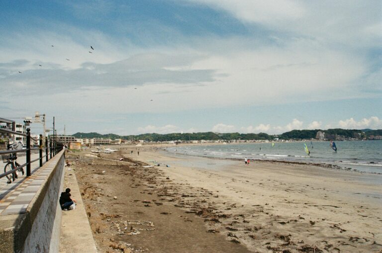Tranquil beach scene with windsurfers in Kamakura, Japan. Perfect summer escape.