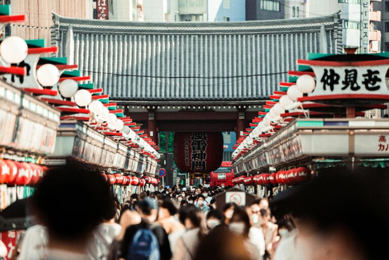 A bustling crowd in Nakamise Street, leading to Senso-ji Temple in Tokyo, Japan.