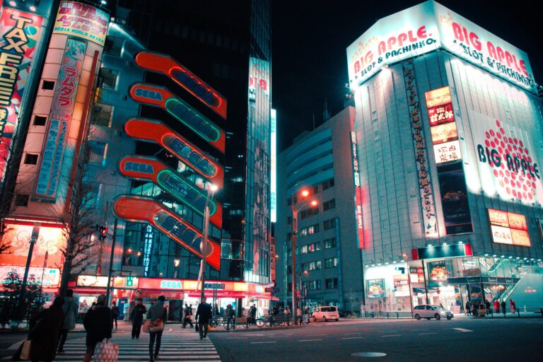 Explore the bustling streets of Akihabara, Tokyo, with glowing neon signs and lively crowds at night.
