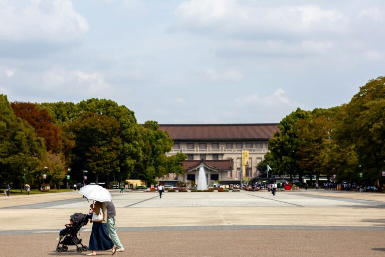 A family walks through Ueno Park in front of the Tokyo National Museum.
