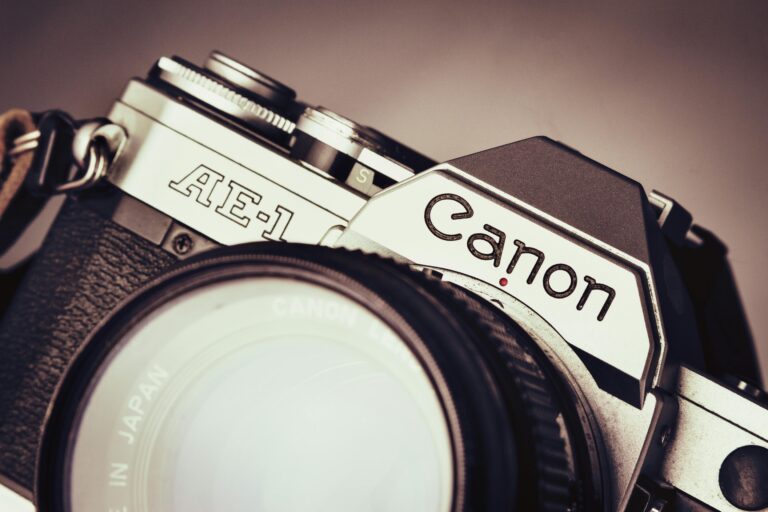 Detailed close-up of a vintage Canon AE-1 camera lens, showcasing retro design.